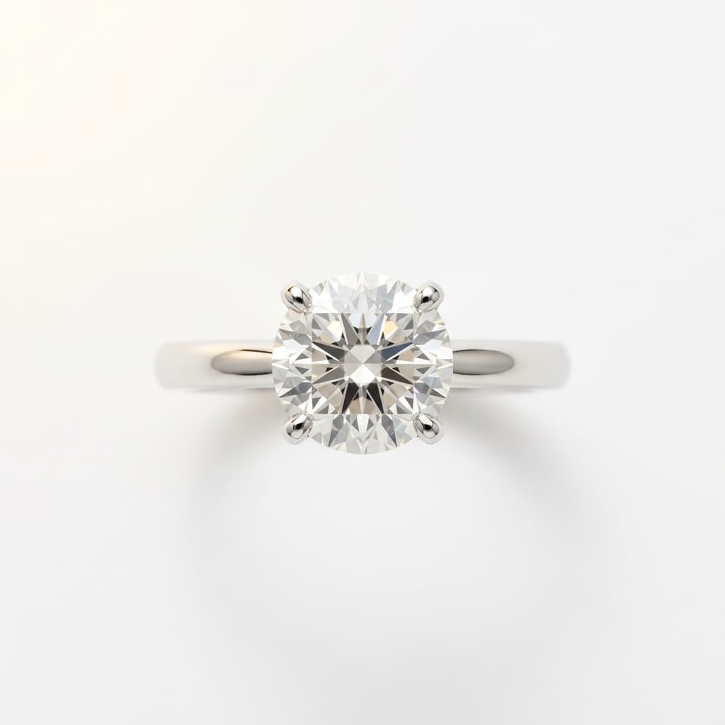 Diamond solitaire ring top-down packshot on pure white, four-prong setting visible — Kraftr jewelry photography