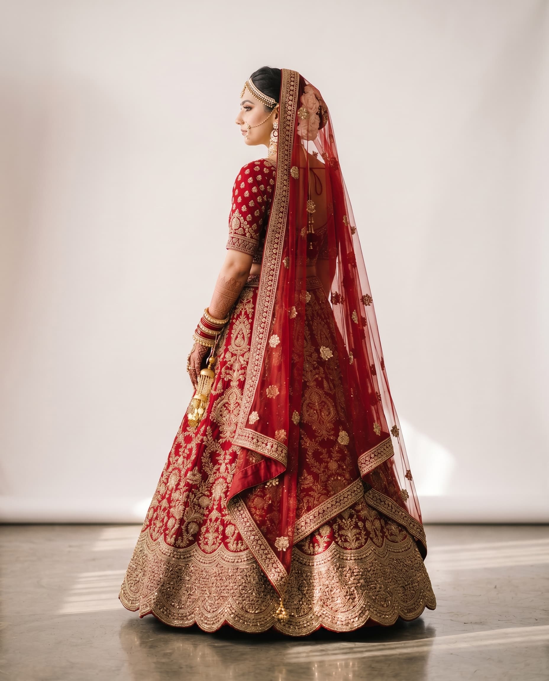 Back view of red bridal lehenga showing dupatta drape and zardosi border